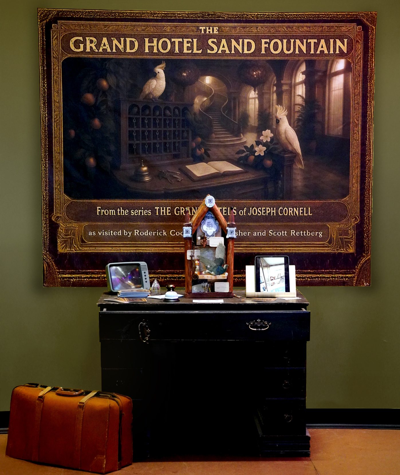 The complete Grand Hotel Sand Fountain installation with backdrop, cabinet, collage, video display, tablet, and suitcase at ELO 2025.