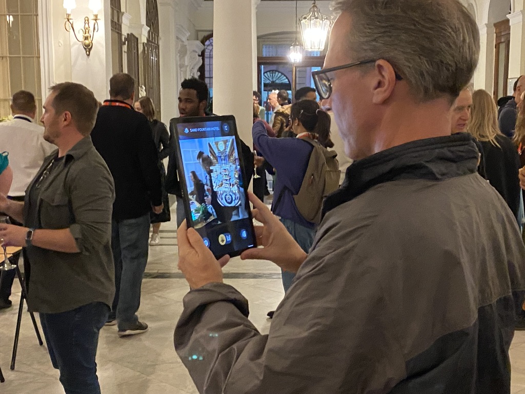 A visitor exploring The Grand Hotel Sand Fountain on a tablet at the ICIDS 2025 exhibition.