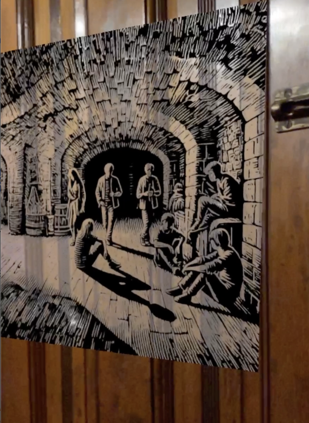 Black-and-white hotel corridor collage mounted on a wooden door.